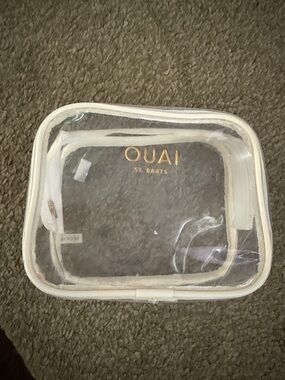OUAI Clear Cosmetic Pouch with White Trim and Gold Logo